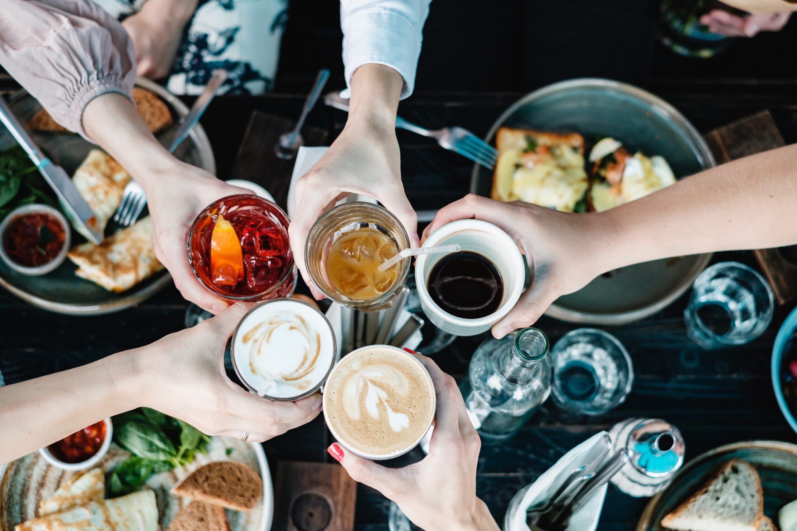 friends toasting at brunch table