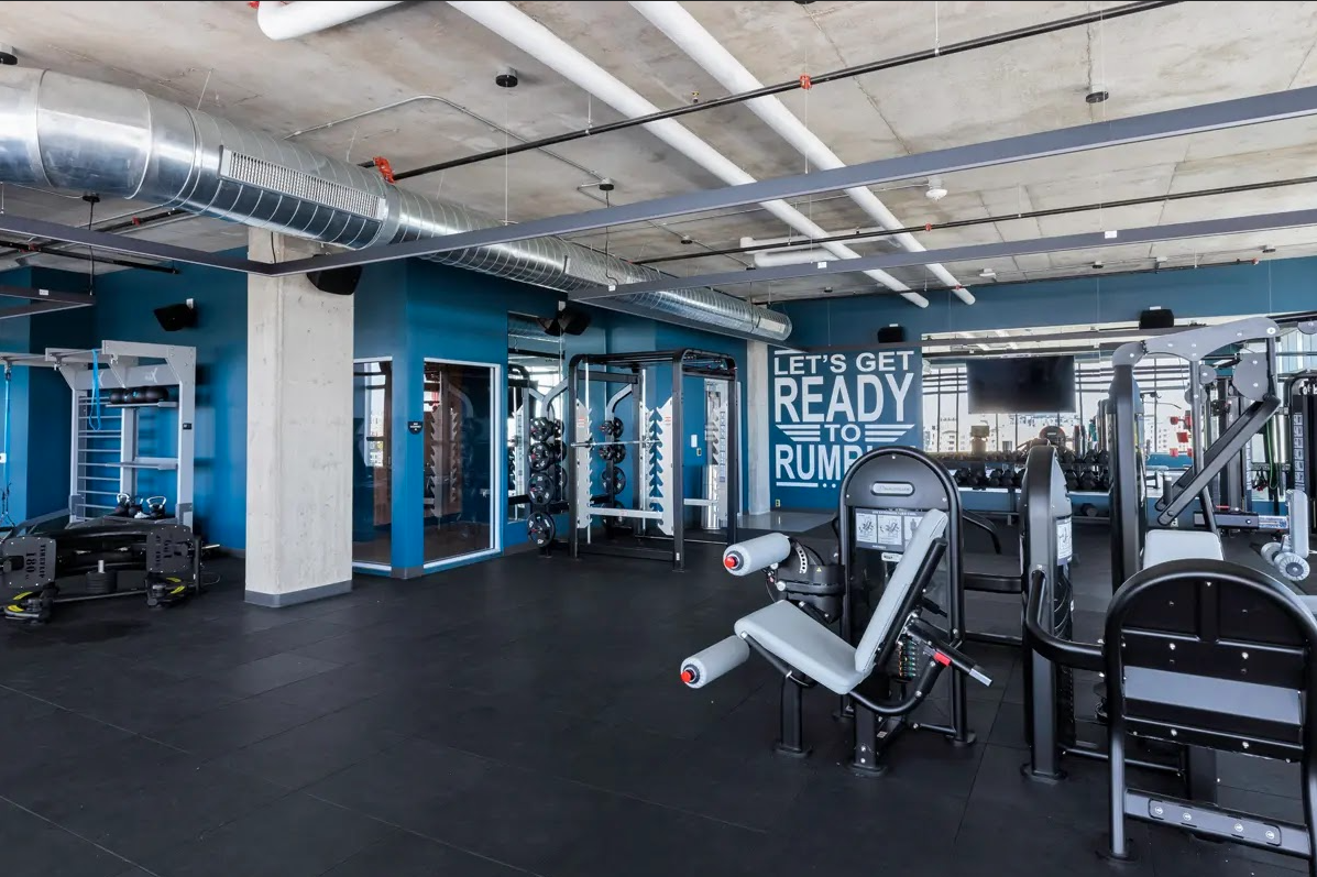 Modern indoor gym with fitness equipment and industrial style
